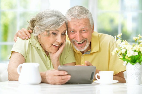 beautiful senior couple using tablet