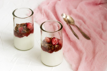 Yogurt with granola and strawberries.