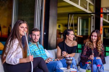 Frends hanging out and smooking hookah