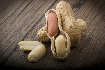 Peanuts in shells close up on the wood table