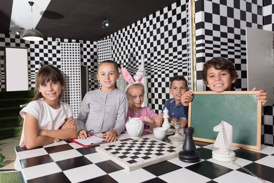 Portrait of children playing in the chess quest room
