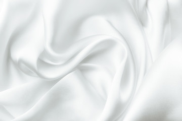 Elegant white satin silk with waves, abstract background.