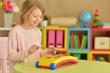 girl playing with musical toy