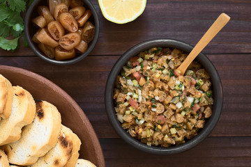 Chilean Pebre Salsa made of Cochayuyo (lat. Durvillaea antarctica) or bull kelp seaweed, tomato, hot aji chili pepper, onion, garlic, parsley, photographed with natural light