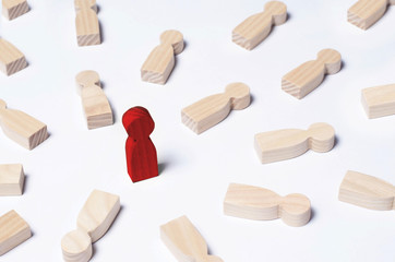 Not like everyone else. The red man stands in the middle of lying opponents. The concept of excellence, business success. An outcast, a schismatic, a bad person. Wooden human figures.