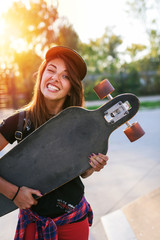 Cute urban girl holding skateboard in skatepark © lordn