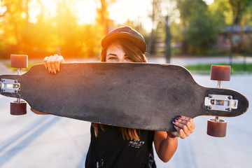 Cute urban girl holding skateboard in skatepark © lordn