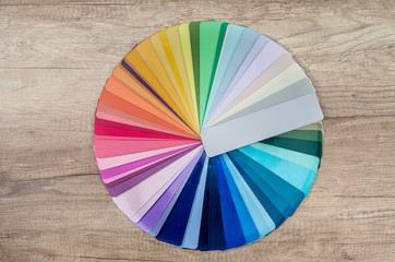 Colour samples decomposed in circle on wooden table