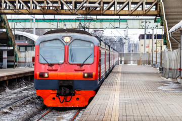 Fototapeta premium Commuter train drives up to the railway station