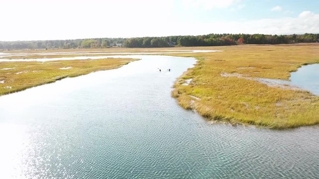 Aerial over kayakers rowing through vast bogs along the Nonesuch River near Portland, Maine, New England.