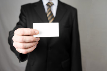 Businessman holding a business card. Mock up. Copy space.