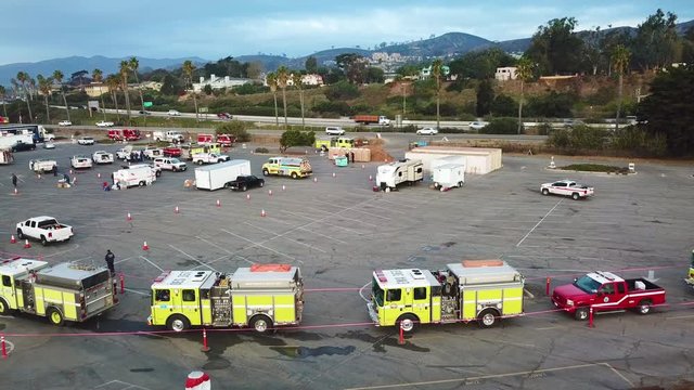 Aerial of firefighters in fire trucks lining up for duty at a staging area during the Thomas Fire in Ventura, California in 2017.