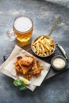 British Fish and chips with beer on dark background