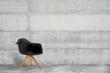 Designer, modern armchair in grey, loft style interior with concrete wall