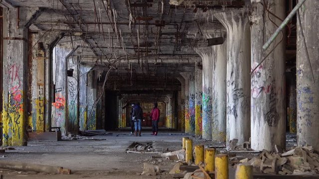 Black kids rap dance and congregate in the abandoned buildings of Detroit, Michigan.