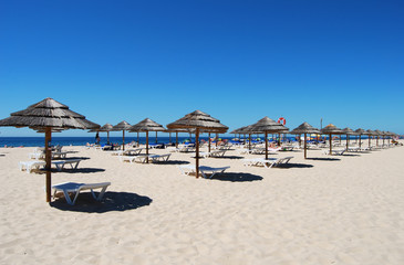 Many Umbrellas on the beach with blue sky in Tavira island,Portugal