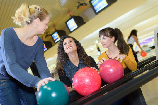 Women collecting bowling balls