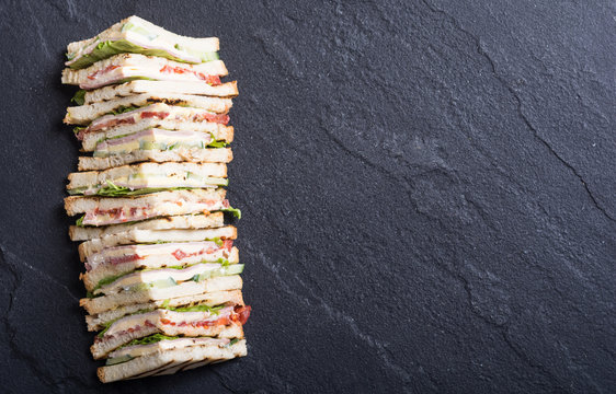 Club sandwich with tomatoes , cucumber , ham and cheese
