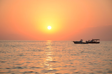 Sea sunset and boat floating