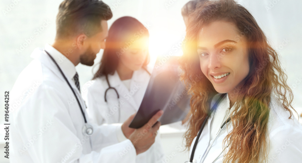 Wall mural confident doctors in hospital looking at x-ray.