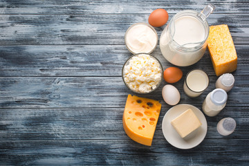 Dairy products grocery assortment on rustic wooden table. Top view.
