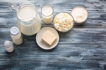 Dairy products grocery assortment on rustic wooden table. Top view.