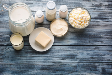 Dairy products grocery assortment on rustic wooden table. Top view.