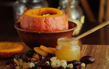 Baked pumpkin with apples, dried fruits and honey. Healthy food.