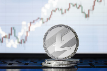 LITECOIN (LTC) cryptocurrency; physical concept litecoin on the background of the chart