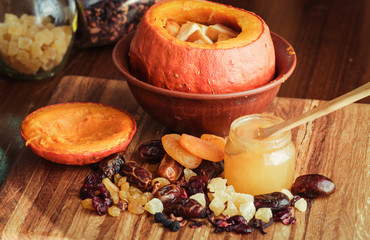 Baked pumpkin with apples, dried fruits and honey. Healthy food.