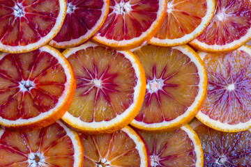round slices of red orange, background and texture