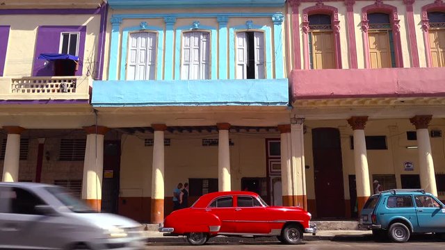A beautiful colorful shot of the old city of Havana, Cuba with classic old cars foreground.