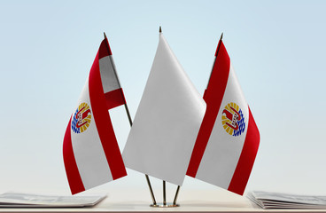 Two flags of French Polynesia with a white flag in the middle