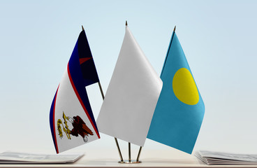 Flags of American Samoa and Palau with a white flag in the middle