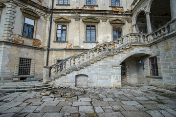 Fototapeta na wymiar A castle yard. Inner yard of a castle with walls and stairs. 