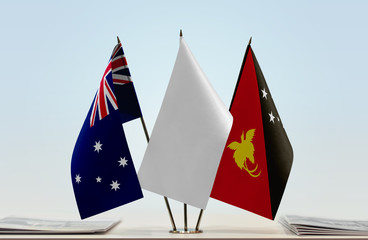 Flags of Australia and Papua New Guinea with a white flag in the middle