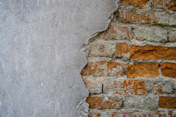 A wall divided into Brick and concrete parts. 