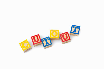 The word CUTOUT made with building blocks