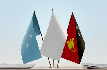Flags of Federated States of Micronesia and Papua New Guinea with a white flag in the middle