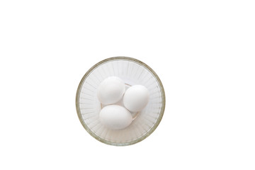 Three white eggs in a bowl isolated on a pure white background top view copy space