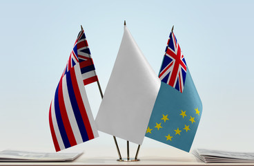 Flags of Hawaii and Tuvalu with a white flag in the middle