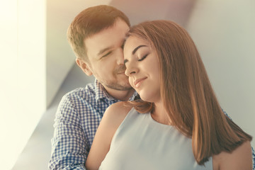 Portrait of young lovely couple at home