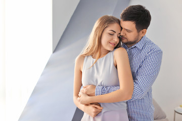 Fototapeta premium Affectionate young couple embracing with closed eyes, romantic relationship and intimacy, love and togetherness