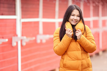 Attractive young woman in warm clothes outdoors