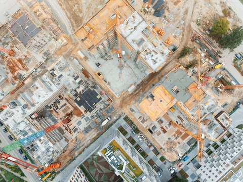 Aerial view of construction site with crane and building. Top view of big development construction and architecture.