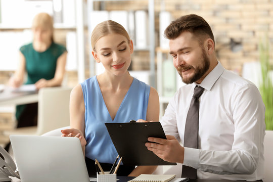 Male receptionist with trainee at workplace