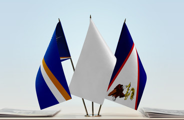 Flags of Marshall Islands and American Samoa with a white flag in the middle