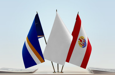 Flags of Marshall Islands and French Polynesia with a white flag in the middle