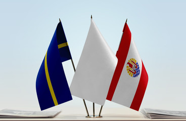 Flags of Nauru and French Polynesia with a white flag in the middle