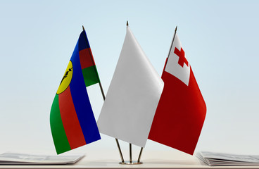 Flags of New Caledonia and Tonga with a white flag in the middle